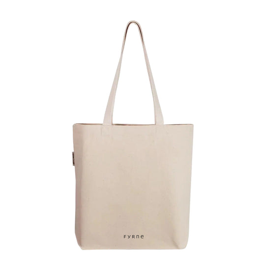 FYRNE logo tote bag — minimalist organic cotton canvas bag with small black FYRNE logo at base, ethically made and designed for everyday use.