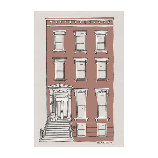 Ivrory tea towel featuring a hand-drawn illustration of an iconic Brooklyn brownstone home.